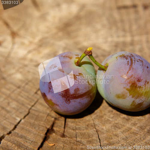 Image of fresh plums on wooden table