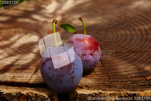 Image of fresh plums on wooden table