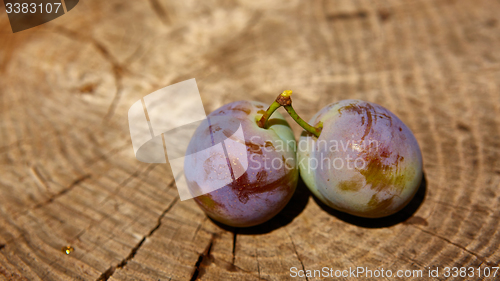 Image of fresh plums on wooden table