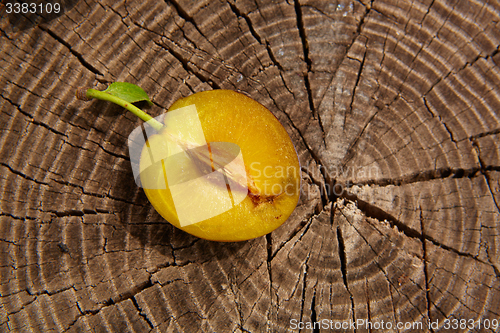 Image of fresh plum on wooden table