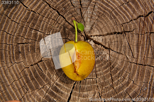 Image of fresh plum on wooden table