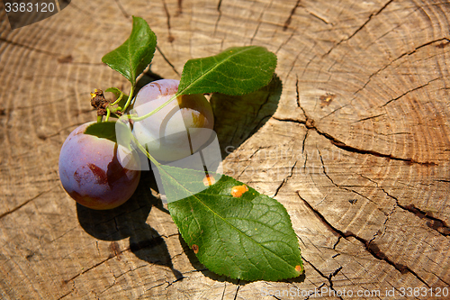 Image of fresh plums on wooden table