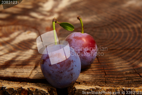 Image of fresh plums on wooden table