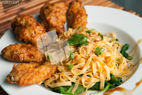 Image of Chicken Wings with Noodles and Spinach