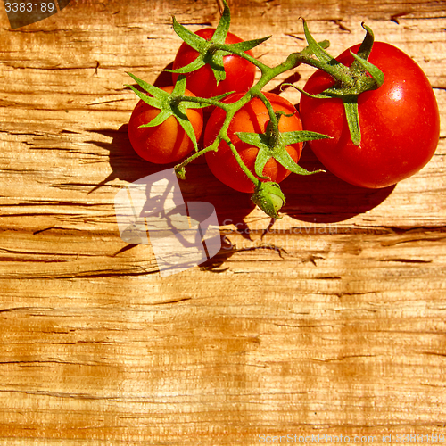 Image of Fresh tomatoes with on wooden table