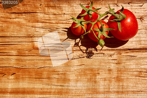 Image of Fresh tomatoes with on wooden table