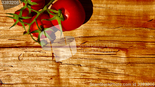 Image of Fresh tomatoes with on wooden table