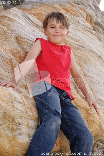 Image of Child standing by a rockface
