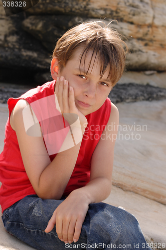 Image of Child sitting on rocks