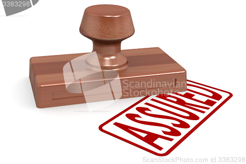 Image of Wooden stamp assured with red text