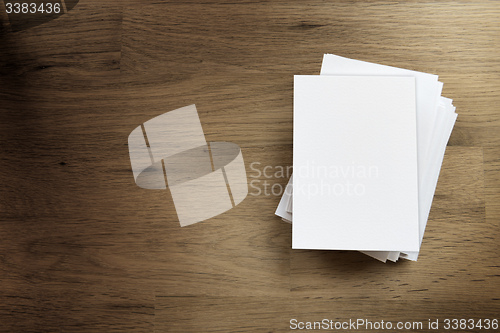 Image of Blank paper card on wooden table