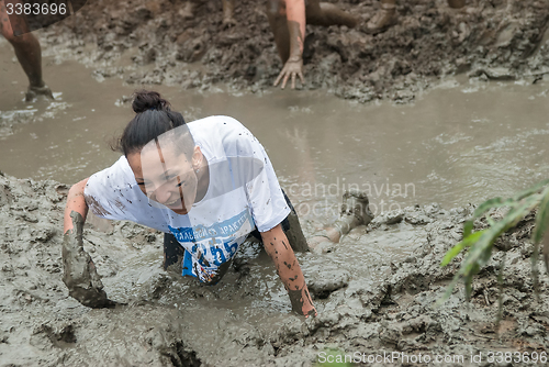 Image of Attractive girl in extrime racing in mud hole