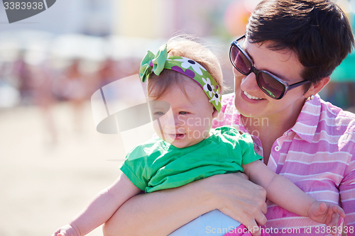 Image of mom and baby on beach  have fun