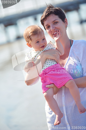 Image of mom and baby on beach  have fun