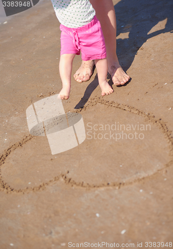 Image of mom and baby on beach  have fun