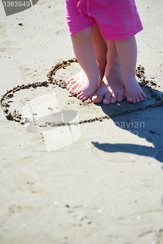 Image of mom and baby on beach  have fun