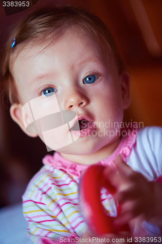 Image of baby playing with toys at home