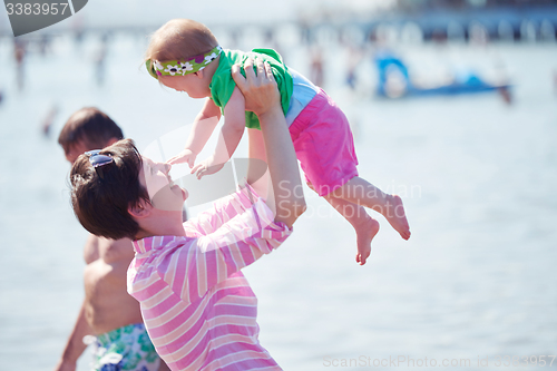 Image of mom and baby on beach  have fun