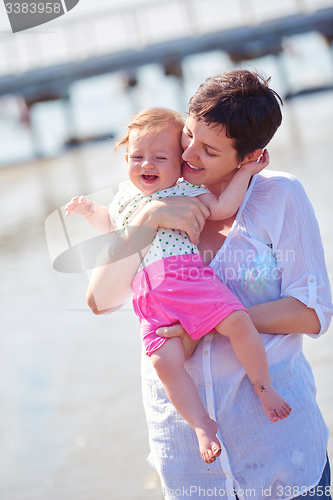 Image of mom and baby on beach  have fun