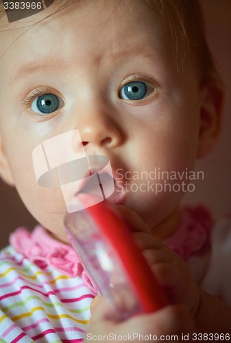 Image of baby playing with toys at home