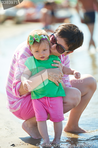 Image of mom and baby on beach  have fun