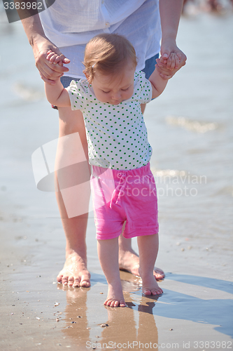 Image of mom and baby on beach  have fun