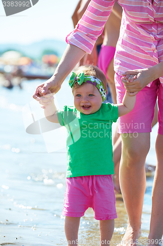 Image of mom and baby on beach  have fun