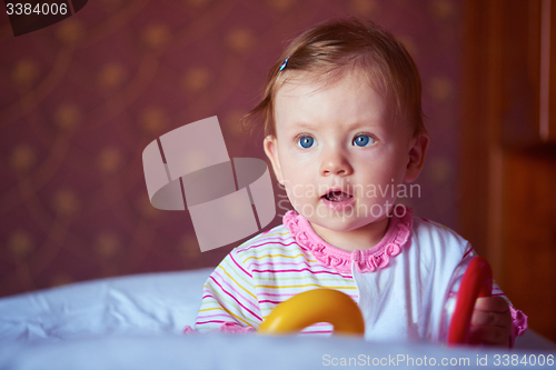 Image of baby playing with toys at home