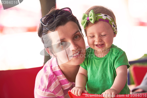 Image of portrait of happy young mother and baby