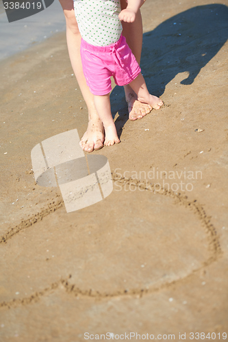 Image of mom and baby on beach  have fun