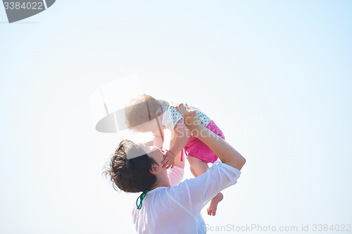 Image of mom and baby on beach  have fun