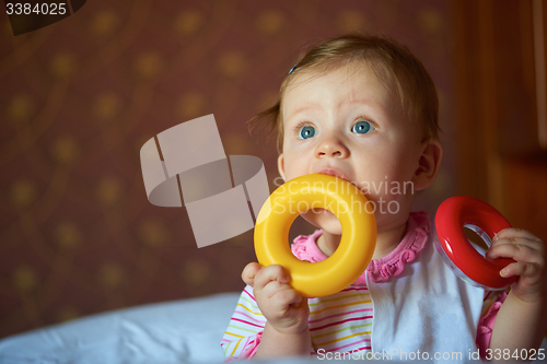 Image of baby playing with toys at home