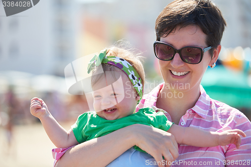 Image of mom and baby on beach  have fun