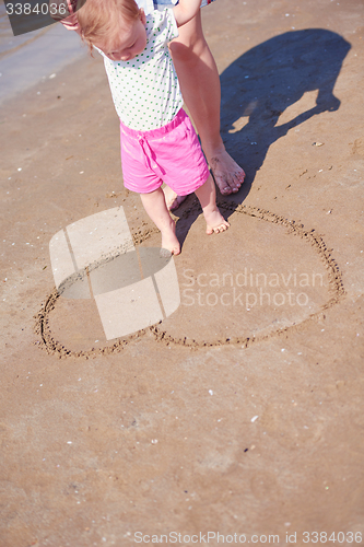 Image of mom and baby on beach  have fun