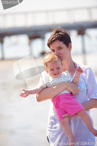 Image of mom and baby on beach  have fun