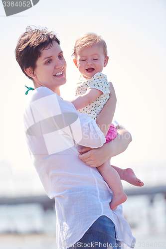 Image of mom and baby on beach  have fun