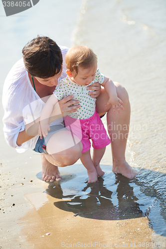 Image of mom and baby on beach  have fun