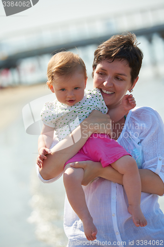 Image of mom and baby on beach  have fun