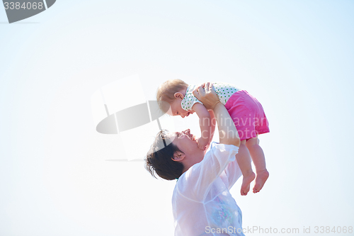 Image of mom and baby on beach  have fun