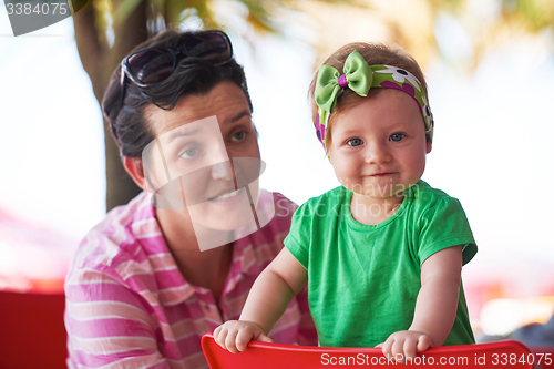 Image of portrait of happy young mother and baby