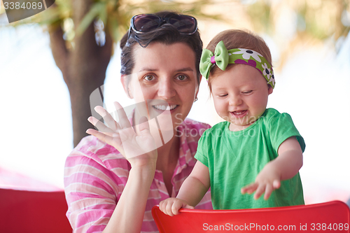 Image of portrait of happy young mother and baby