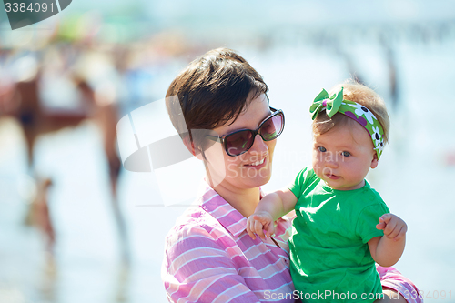 Image of mom and baby on beach  have fun