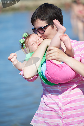 Image of mom and baby on beach  have fun