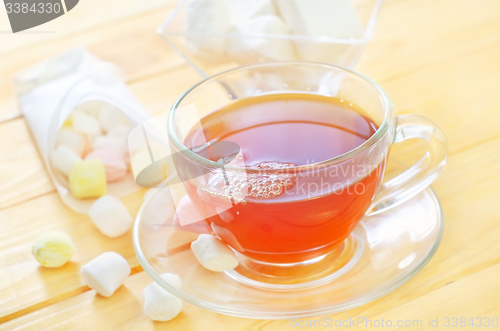 Image of Fresh tea with candy