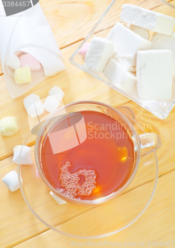 Image of Fresh tea with candy