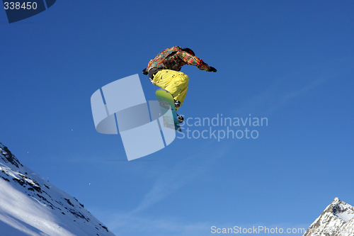 Image of Snowboarder jumping high in the air