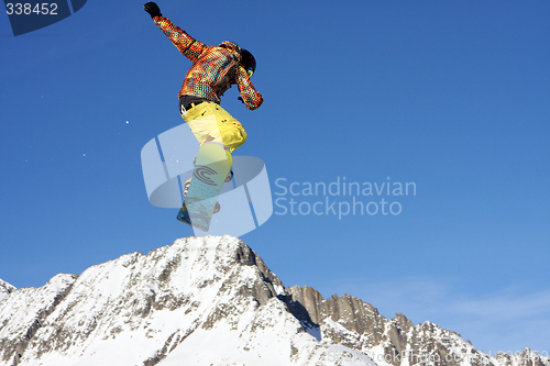 Image of Snowboarder jumping high in the air