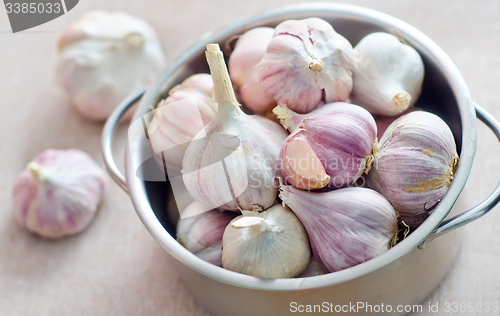 Image of garlic in metal bowl on the table