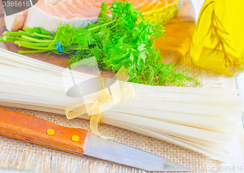 Image of raw rice noodles and raw salmon