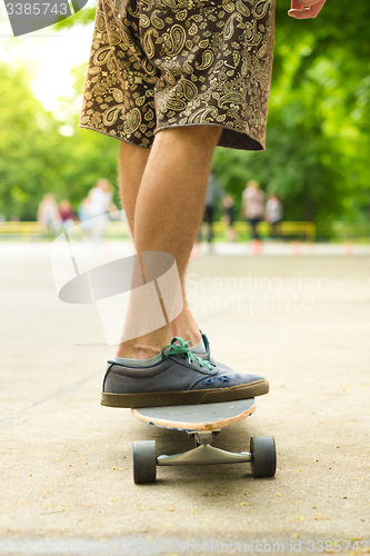 Image of Guy riding long board.